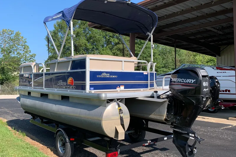 Slide: The Image of 2014 SUNTRACKER PARTY BARGE 18 pontoon boat with Mercury outboard motor on trailer. - 3
