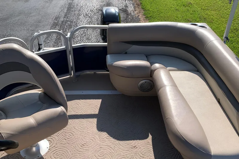Slide: The Image of 2014 SUNTRACKER PARTY BARGE 18 interior with beige seating and carpet. - 6
