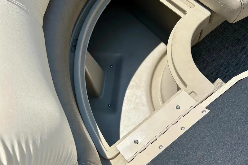 Slide: The Image of Storage compartment in 2017 Starcraft CX 23 RE boat, featuring beige upholstery and durable materials. - 11