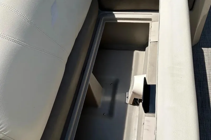 Slide: The Image of 2017 Starcraft CX 23 RE boat seat storage compartment, open and empty. - 12