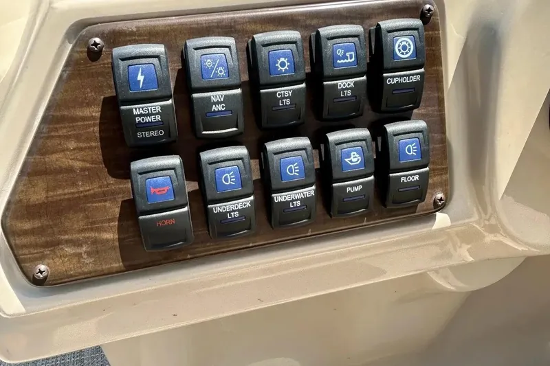 Slide: The Image of Control panel of a 2017 Starcraft CX 23 RE boat with labeled switches. - 21