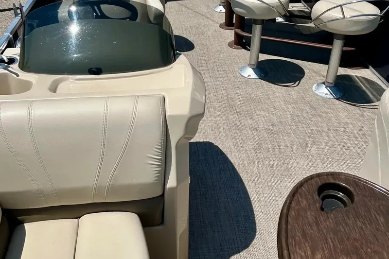 Slide: The Image of 2017 Starcraft CX 23 RE boat interior with beige seating and carpeted floor. - 27