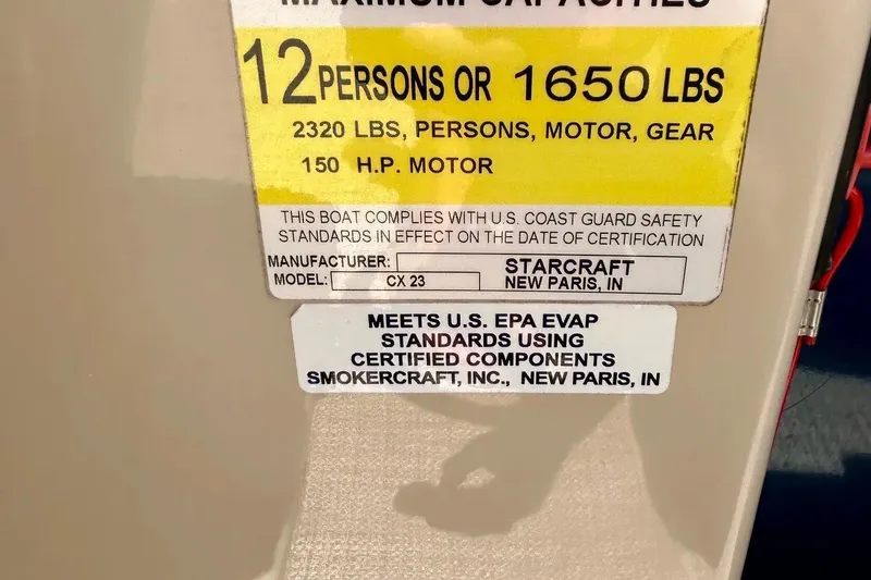 Slide: The Image of 2017 Starcraft CX 23 RE boat capacity label, 12 persons or 1650 lbs, 150 HP motor. - 28