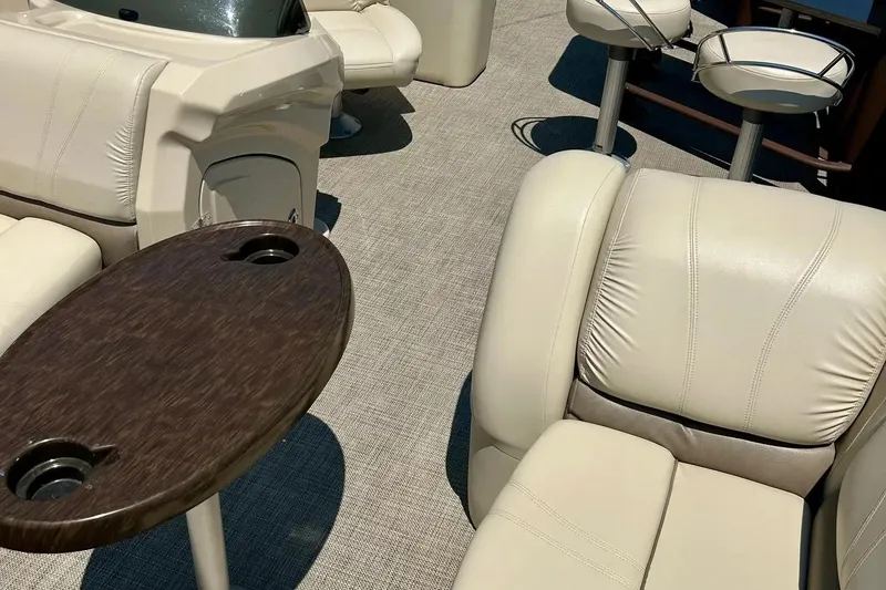 Slide: The Image of Luxurious interior of 2017 Starcraft CX 23 RE pontoon boat with plush seating and table. - 35