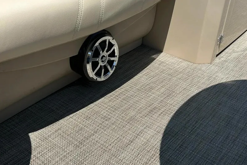 Slide: The Image of 2017 Starcraft CX 23 RE boat interior with speaker and beige upholstery. - 36