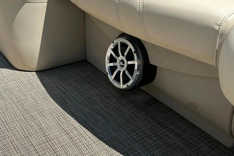 Slide: The Image of 2017 Starcraft CX 23 RE boat interior with speaker and beige seating. - 37