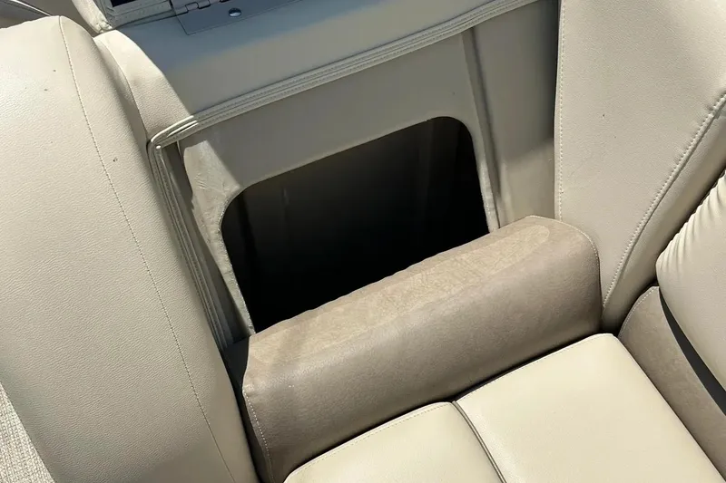 Slide: The Image of 2017 Starcraft CX 23 RE boat interior with beige seating and storage compartment. - 39