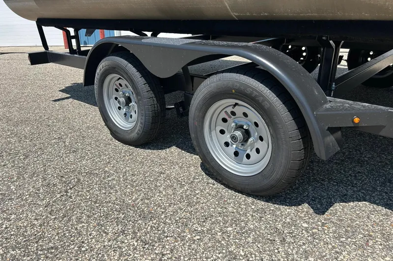 Slide: The Image of Trailer wheels of a 2017 Starcraft CX 23 RE on a paved surface. - 6