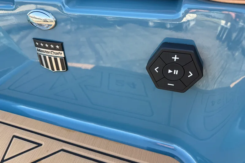Slide: The Image of 2025 MasterCraft XT24 boat with control panel and logo on blue exterior. - 12