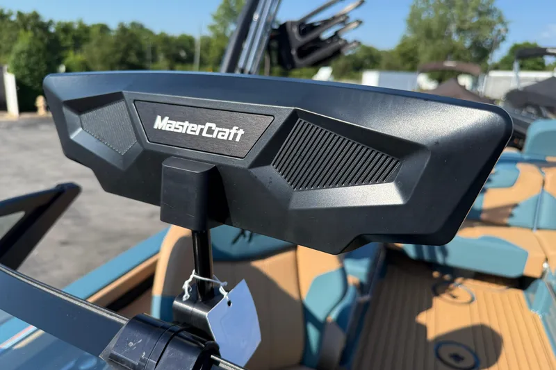 Slide: The Image of 2025 MasterCraft XT24 boat dashboard with logo, featuring modern design and blue interior. - 18
