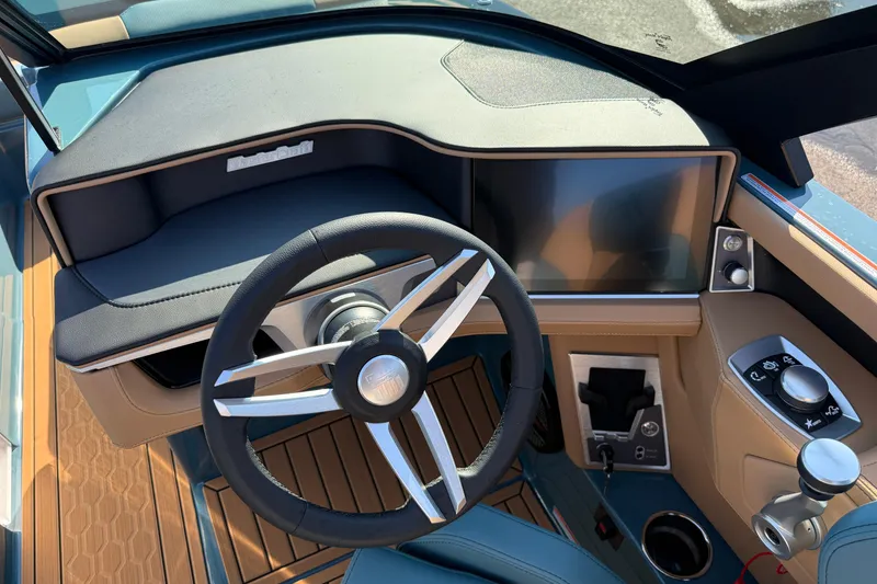 Slide: The Image of 2025 MasterCraft XT24 boat dashboard with steering wheel and touchscreen display. - 20