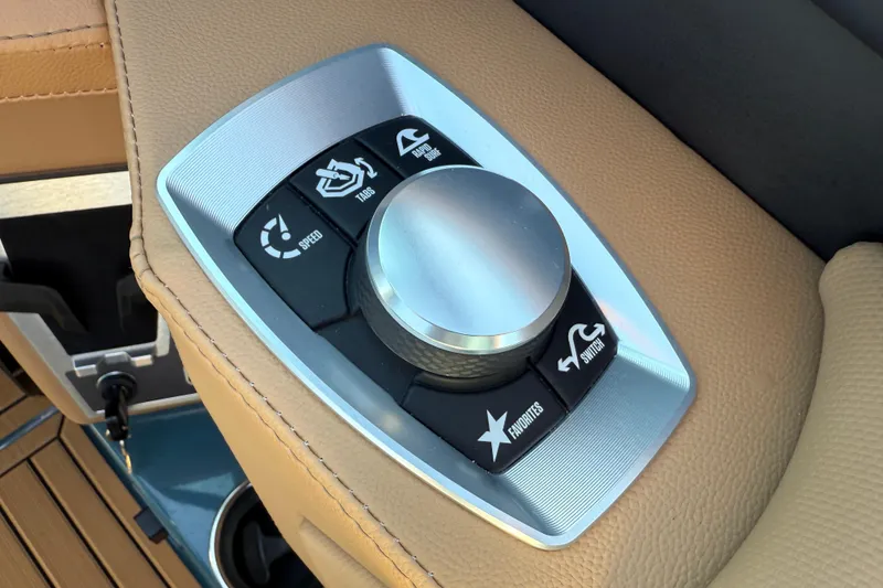 Slide: The Image of 2025 MasterCraft XT24 control panel with speed and function buttons on tan leather. - 21