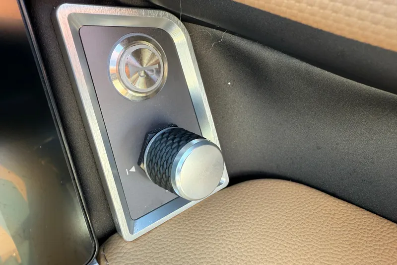 Slide: The Image of Control knob in 2025 MasterCraft XT24 boat interior, featuring sleek design and textured grip. - 22