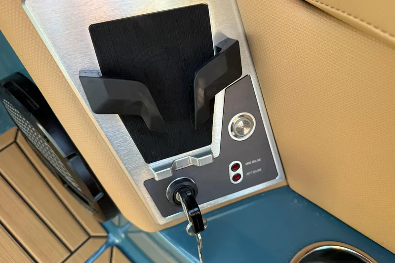 Slide: The Image of Control panel of 2025 MasterCraft XT24 boat with key ignition and bilge switches. - 23