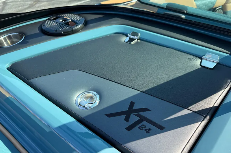 Slide: The Image of 2025 MasterCraft XT24 boat interior detail with speaker and cup holder. - 29