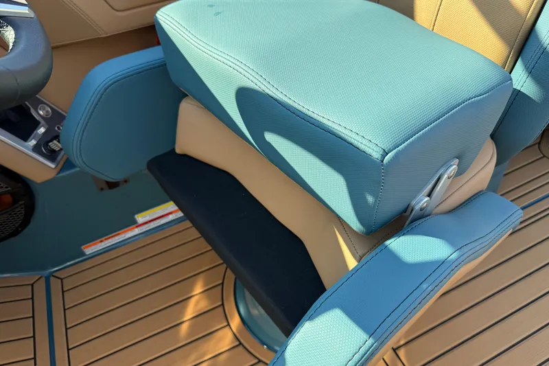 Slide: The Image of 2025 MasterCraft XT24 boat seat with teal upholstery and tan accents. - 31