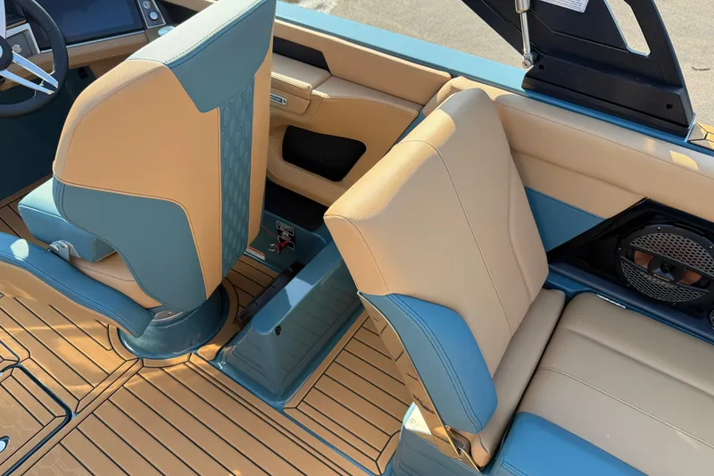 Slide: The Image of 2025 MasterCraft XT24 interior with tan and blue seating, featuring modern design and speaker system. - 33