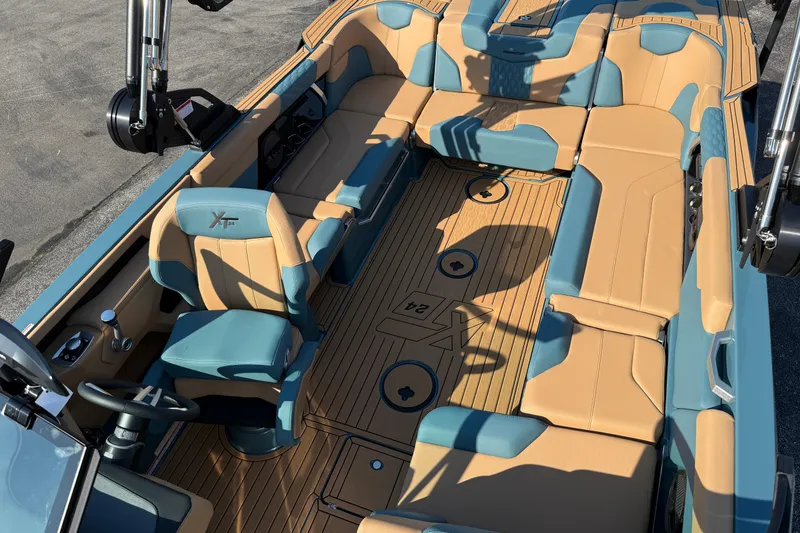 Slide: The Image of 2025 MasterCraft XT24 boat interior with tan and teal seating, showcasing luxury design. - 40