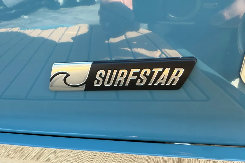 Slide: The Image of 2025 MasterCraft XT24 SurfStar logo on blue boat surface. - 7