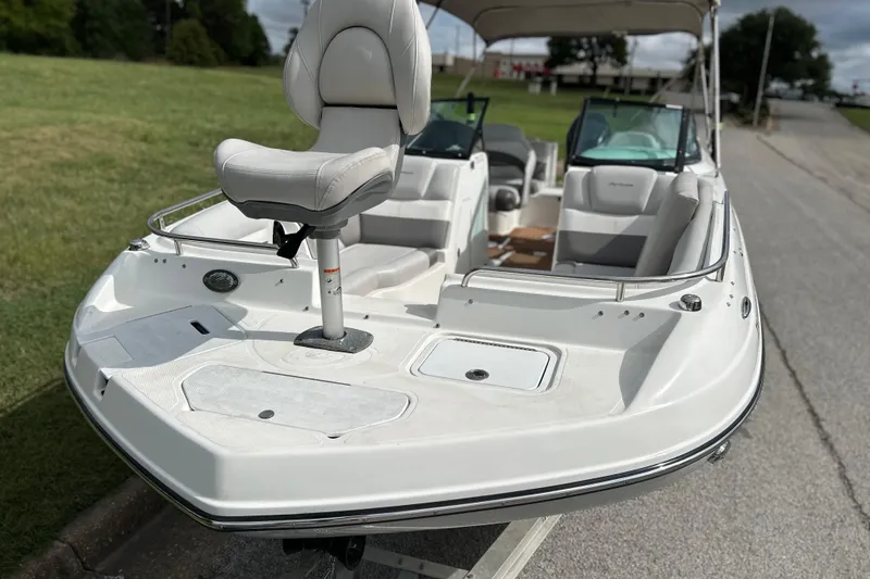 Slide: The Image of 2017 Hurricane SD 2486 boat on trailer, parked outdoors under cloudy sky. - 10
