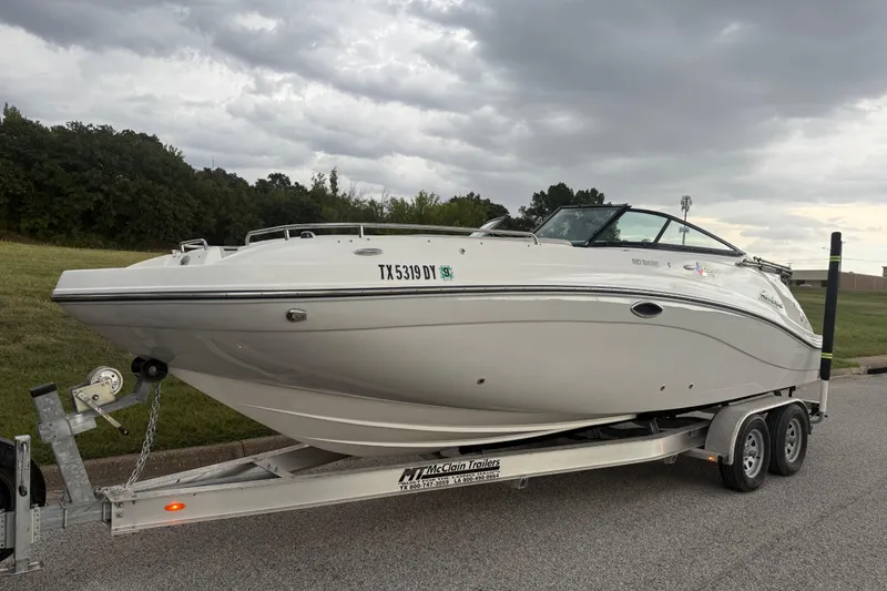 Slide: The Image of 2017 Hurricane SD 2486 boat on trailer, parked on roadside with lush greenery. - 12