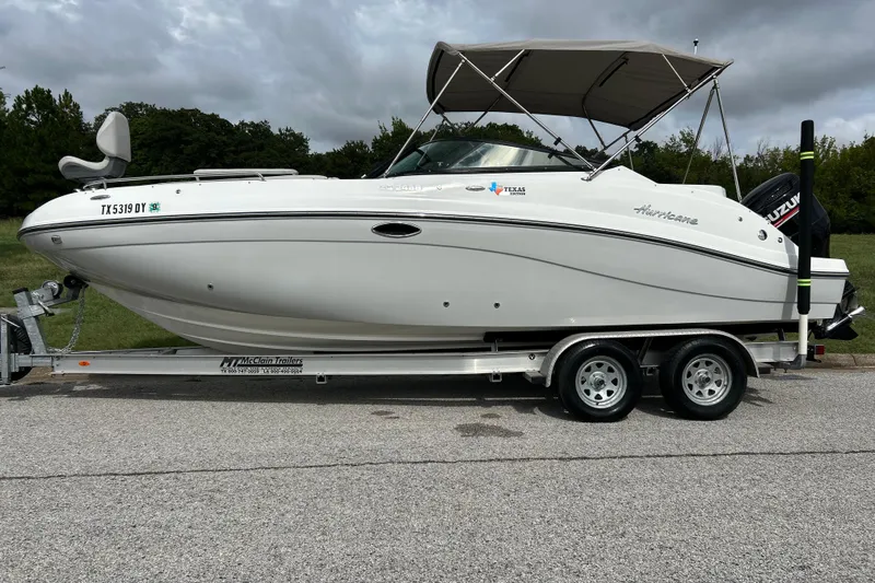 Slide: The Image of 2017 Hurricane SD 2486 boat on trailer, parked on roadside under cloudy sky. - 13