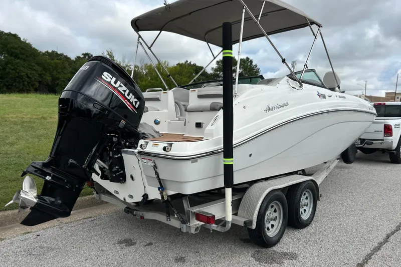 Slide: The Image of 2017 Hurricane SD 2486 boat on trailer, parked on road with cloudy sky background. - 14