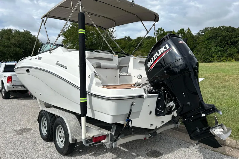 Slide: The Image of 2017 Hurricane SD 2486 boat on trailer, parked outdoors under clear blue sky. - 16