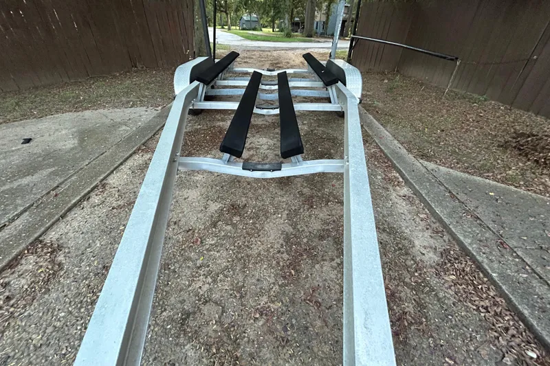 Slide: The Image of Close-up of a 2017 Hurricane SD 2486 trailer wheel on a paved road. - 26