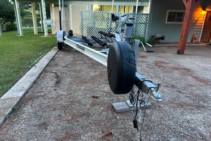 Slide: The Image of Boat trailer for 2017 Hurricane SD 2486, parked on a concrete path. - 27