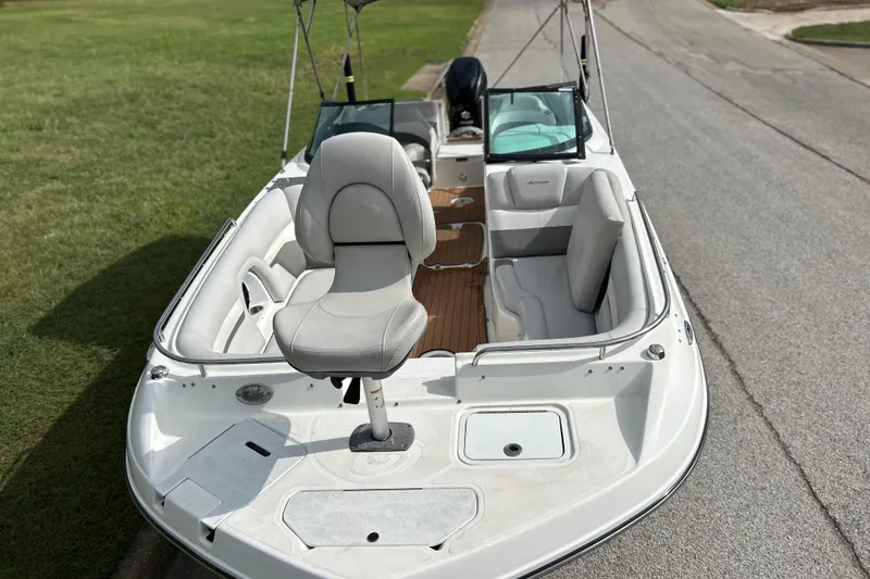 Slide: The Image of 2017 Hurricane SD 2486 boat on trailer, parked on roadside with trees in background. - 3