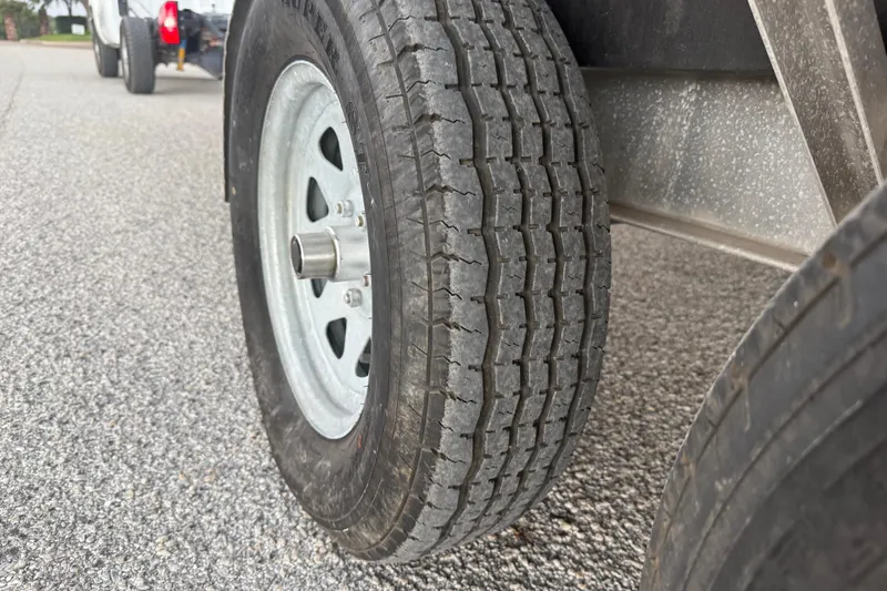 Slide: The Image of Trailer for 2017 Hurricane SD 2486 boat, parked on gravel driveway. - 30