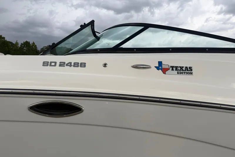 Slide: The Image of 2017 Hurricane SD 2486 boat logo on white surface. - 32