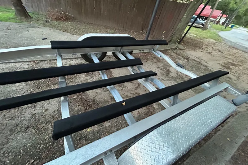 Slide: The Image of Trailer hitch and winch of 2017 Hurricane SD 2486 boat on pavement. - 34