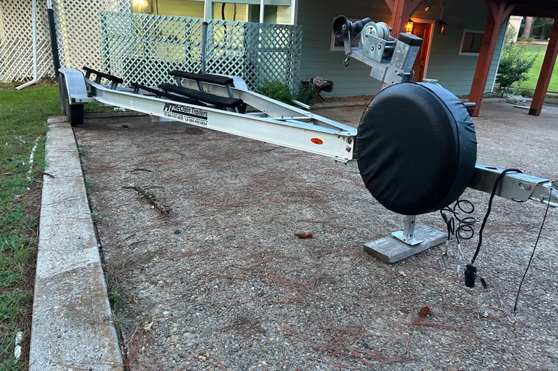 Slide: The Image of Boat trailer for 2017 Hurricane SD 2486, parked on a tree-lined driveway. - 36