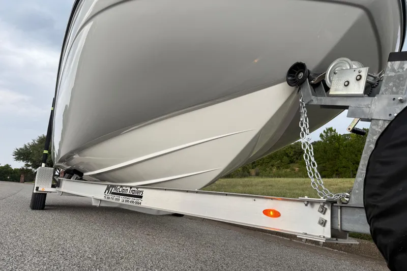Slide: The Image of 2017 Hurricane SD 2486 boat on trailer, parked on roadside with grassy background. - 39