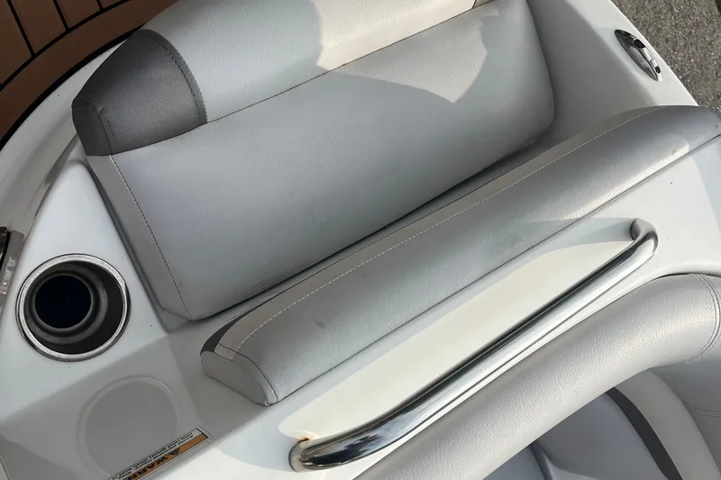 Slide: The Image of 2017 Hurricane SD 2486 boat interior with white cushioned seating and stainless steel cup holder. - 42