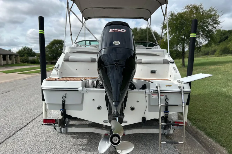 Slide: The Image of 2017 Hurricane SD 2486 boat on trailer, parked outdoors under cloudy sky. - 7
