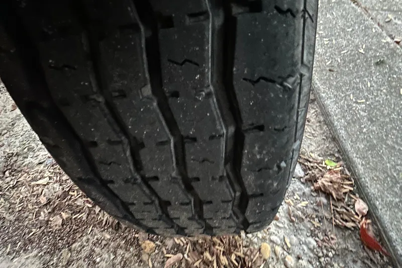 Slide: The Image of 2017 Hurricane SD 2486 boat interior with white seating and wooden flooring. - 84