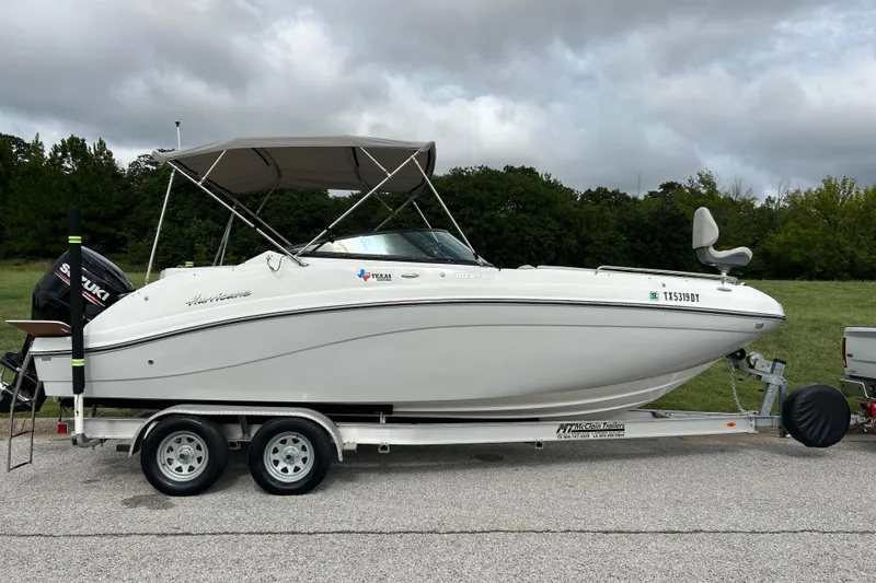 Slide: The Image of 2017 Hurricane SD 2486 boat on trailer, parked outdoors under clear sky. - 9