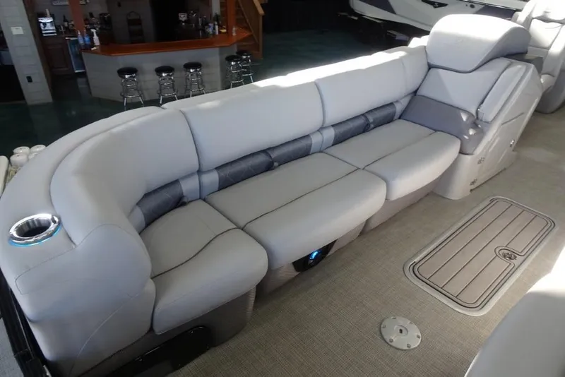 Slide: The Image of 2024 Regency 250 LE3 boat interior with plush seating and cup holder. - 13