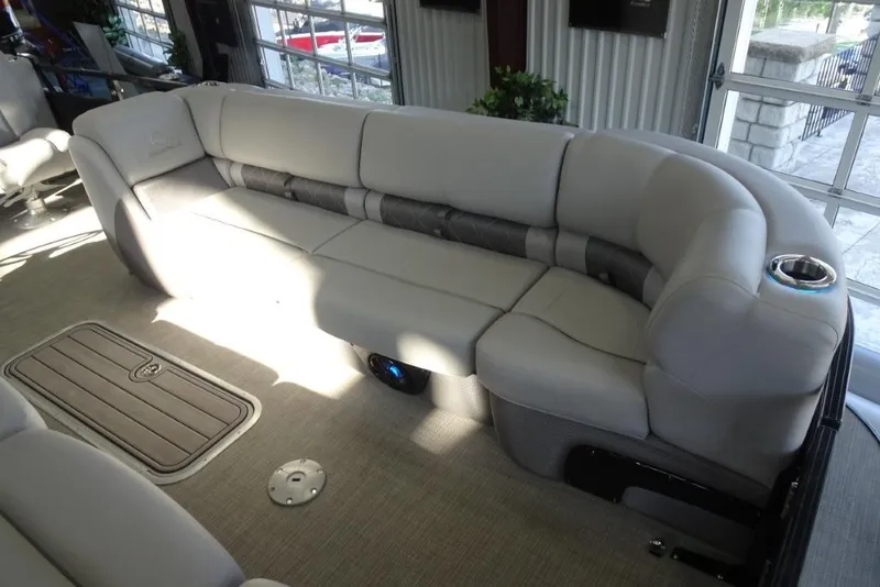 Slide: The Image of Luxurious seating on 2024 Regency 250 LE3 pontoon boat, featuring plush upholstery and cup holder. - 14