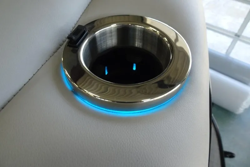 Slide: The Image of Illuminated cup holder on 2024 Regency 250 LE3 boat, featuring sleek design and blue LED lighting. - 15