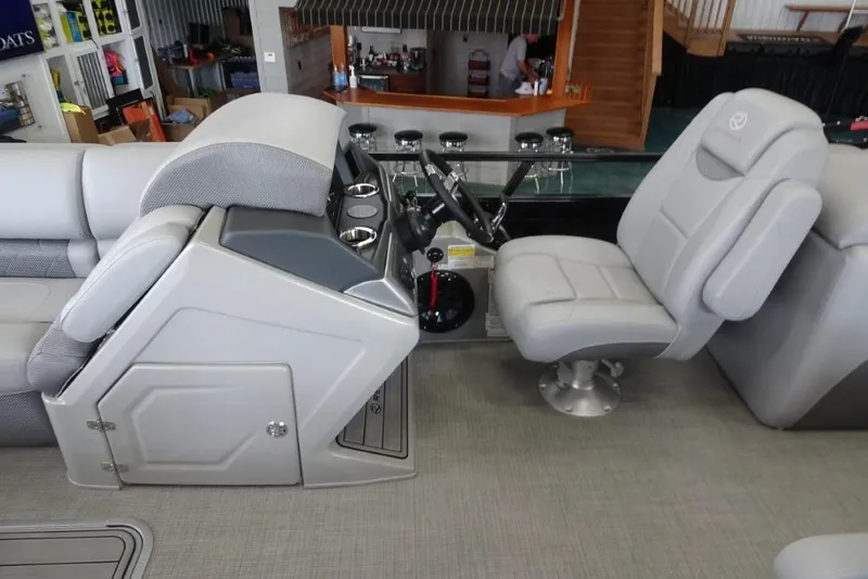 Slide: The Image of 2024 Regency 250 LE3 boat interior with steering console and seating. - 17