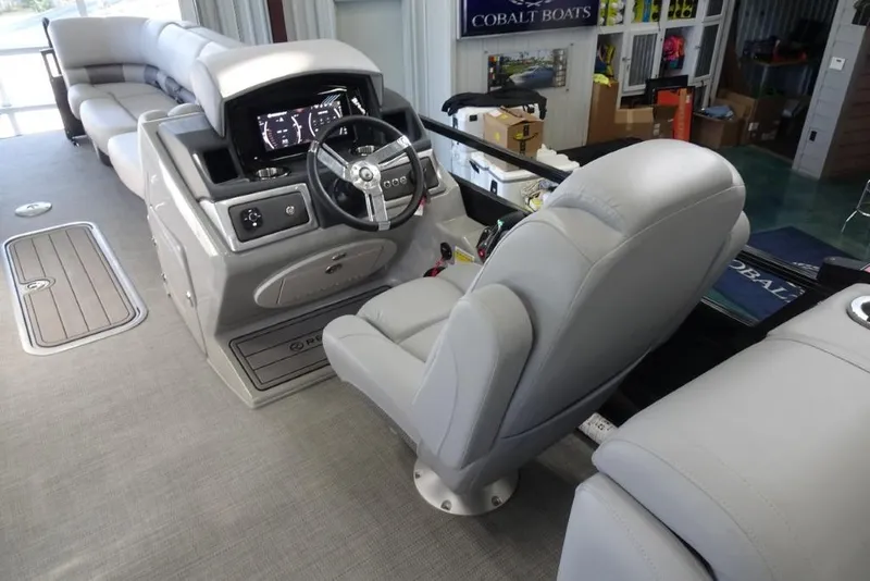 Slide: The Image of 2024 Regency 250 LE3 boat interior with steering console and plush seating. - 18