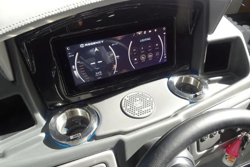 Slide: The Image of 2024 Regency 250 LE3 dashboard with touchscreen display and cup holders. - 20