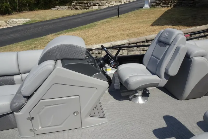 Slide: The Image of 2024 Regency 250 LE3 boat interior with gray seating and steering console. - 29