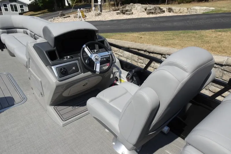 Slide: The Image of 2024 Regency 250 LE3 boat interior with gray seating and steering console. - 30