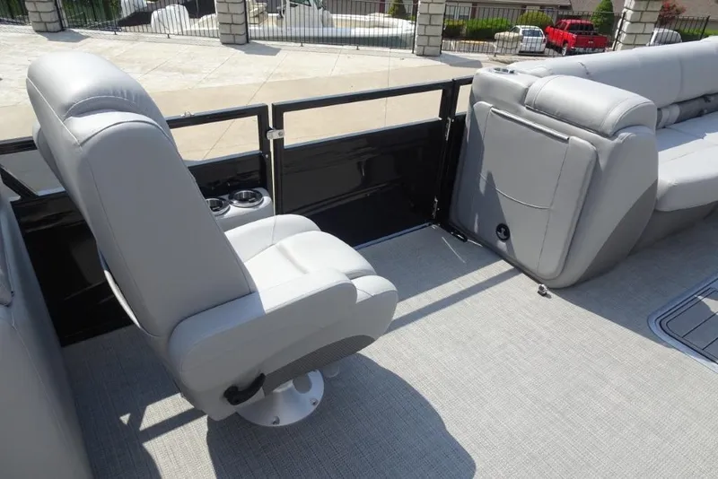 Slide: The Image of 2024 Regency 250 LE3 boat interior with gray seating and cup holders. - 31