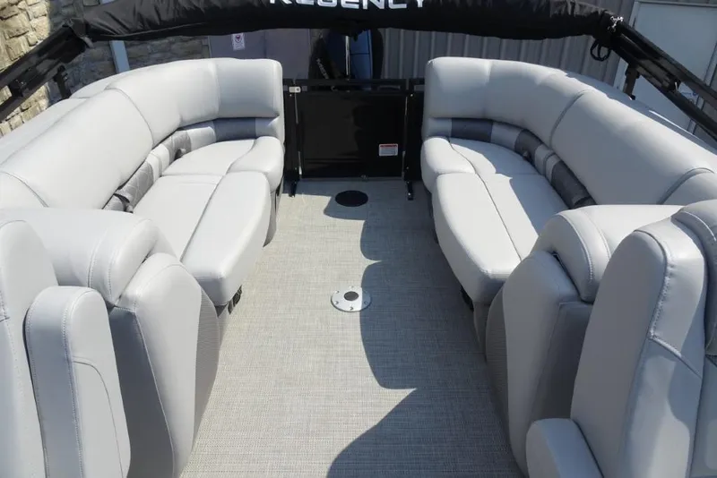 Slide: The Image of 2024 Regency 250 LE3 pontoon boat interior with plush gray seating and spacious layout. - 32